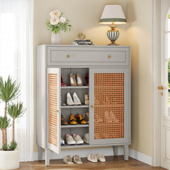 “Gray shoe cabinet with rattan doors and drawers styled in entryway”


