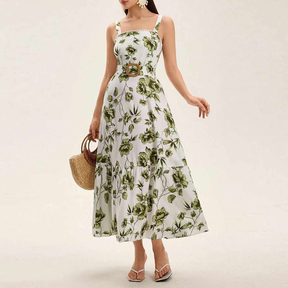 Woman wearing a green floral belted maxi dress styled for a summer brunch with a white background