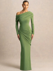 Woman wearing a green one-shoulder ruched maxi dress against beige background