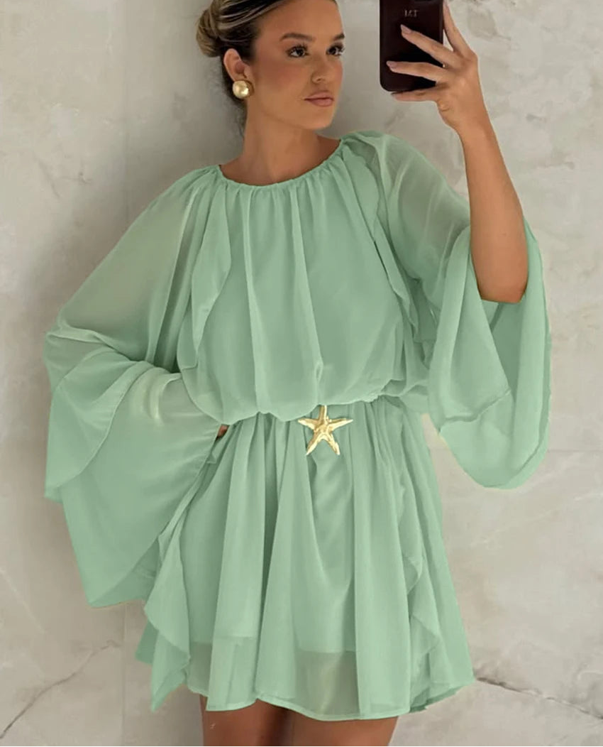 Green ruffle mini dress with long sleeves styled for vacation and city escapes