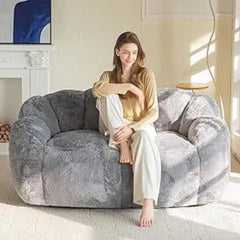 “Close-up of grey faux fur floral bean bag with petal-shaped design”

