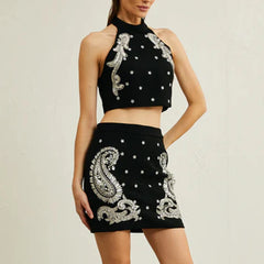 Black two-piece set styled for an evening look, showing balanced proportions and confident stance.