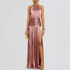 A woman wearing a halter high-split maxi dress in an elegant, modern style.