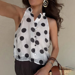 A close-up shot of the halter neck and polka dot print on the top.