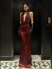 Burgundy halter evening gown with a sequin bodice and deep V neckline