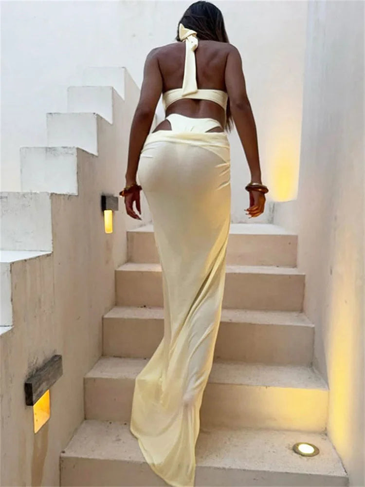 Women climbing a stair ,back view of floor-length mesh skirt and top combo .
