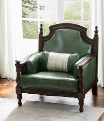 Green leather armchair with wooden frame in a room with large windows.