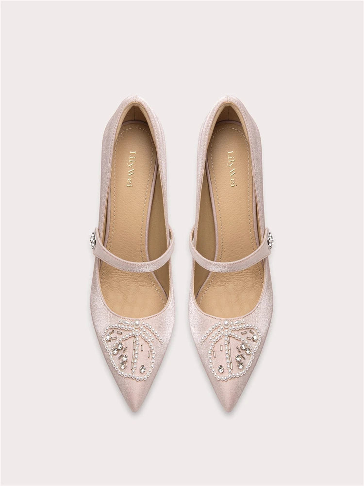 A front view of a high-heel pump, highlighting the thin heel and elegant design.