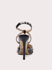 A front view of a high-heel sandal, highlighting the thin heel and buckle strap.