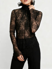 Detailed shot of the ruffled high neck and lightweight lace fabric emphasizing its refined, statement-making finish.