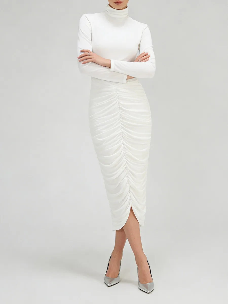Model standing in a high-neck long sleeve midi dress with gathered ruching and a streamlined silhouette
