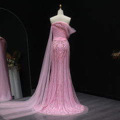 The full length of the formal gown, showing the high leg slit and the flowing skirt.