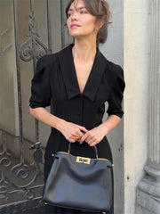 Full-length view of a tailored two-piece trouser set with clean lines