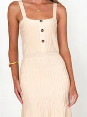High-waist sleeveless knit dress styled in a neutral  setting
