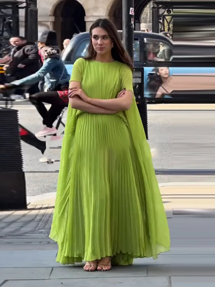 High-waist lime green pleated gown flowing in the breeze