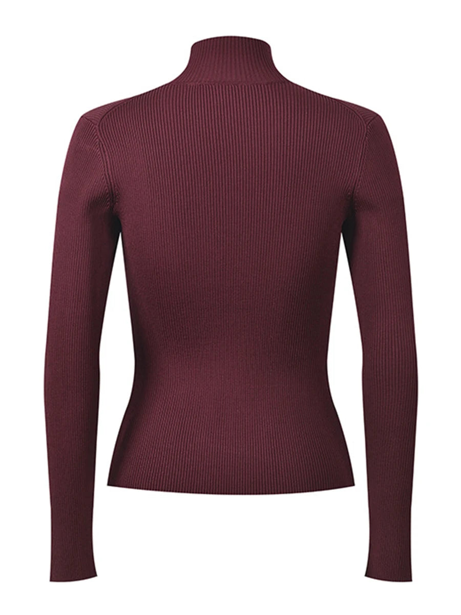 Front view of a ribbed knit turtleneck top with vertical texture and cutout accents