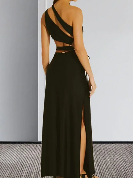 Black hollow patchwork slim fit summer dress in black, shown with a chain bag with a high slit on a neutral background