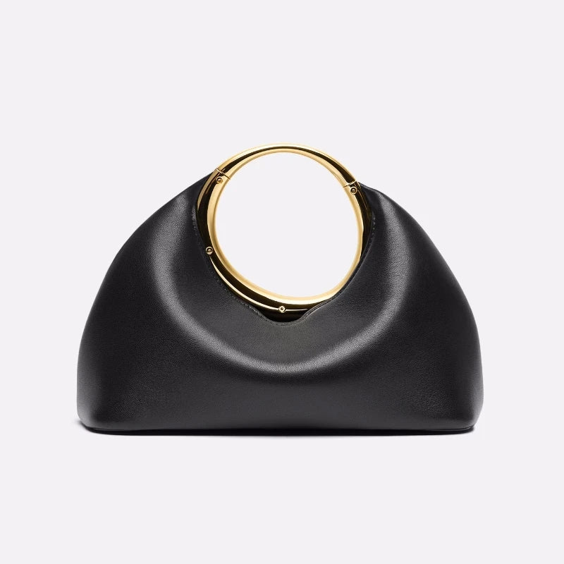 Iconic gold handle minimalist clutch displayed as modern fashion purse