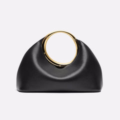 Iconic gold handle minimalist clutch displayed as modern fashion purse