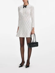 Round neck mini dress featuring a refined bow detail at the collar