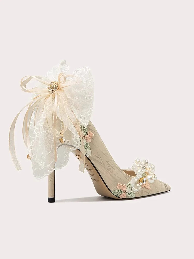 Ivory floral bow wedding pumps styled for bridal celebrations