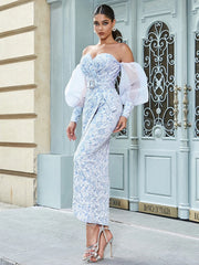 A close-up of the jacquard fabric and belt detail on the dress.

