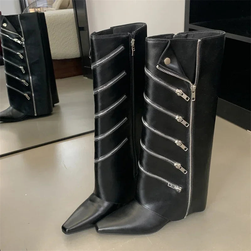 Close-up shot of the knee-high boots showing the pointed toe and wedge heel.

