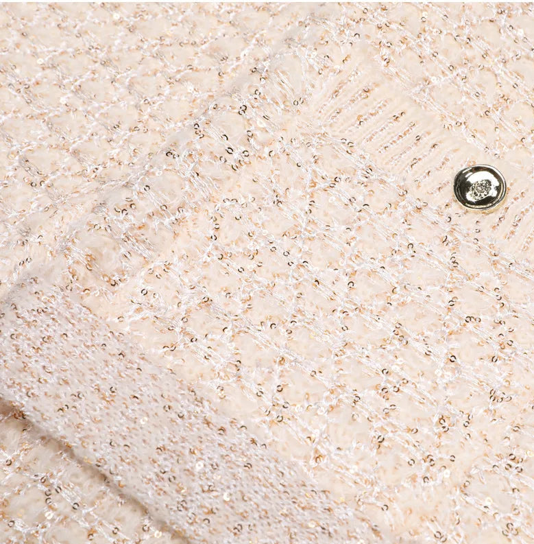 Flat presentation of the knit coat showing overall structure, fabric texture, and clean construction details.