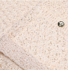 Flat presentation of the knit coat showing overall structure, fabric texture, and clean construction details.