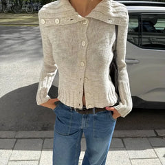 A close-up shot of the button-up detail and knit fabric texture.