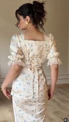 Close-up of lace-up back detail on white floral midi dress