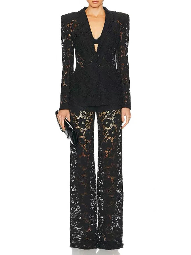 Black sequin outfit with a deep neckline and wide-leg pants on a white background