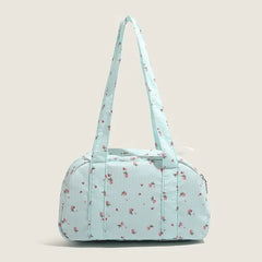 Vintage-inspired blue floral canvas handbag with pink blossoms