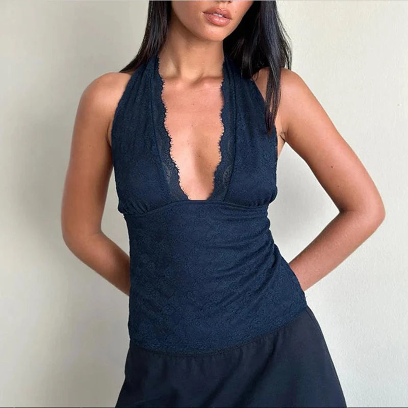 A woman modeling a lace halter crop top with a low V-neck.