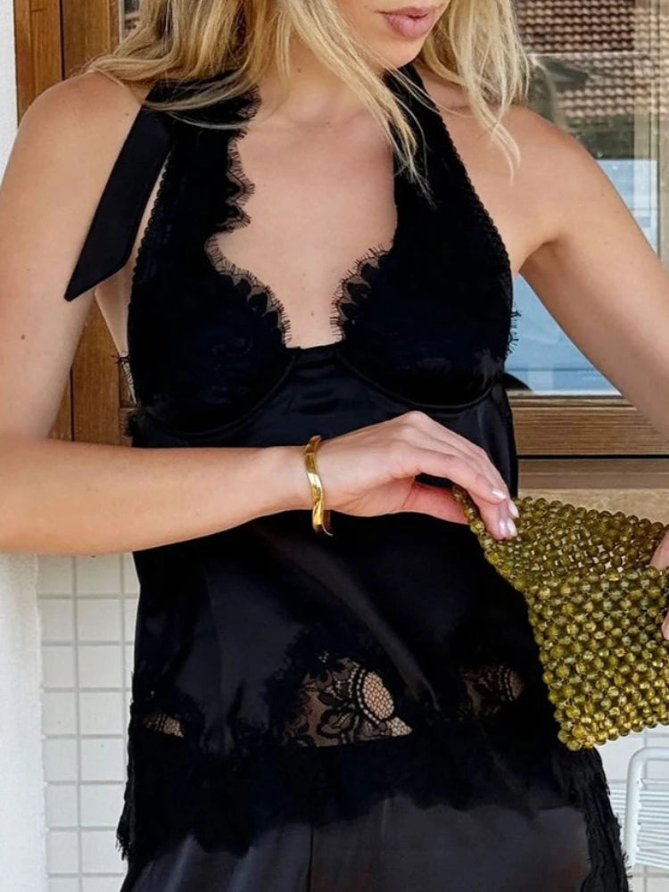 Black lace halter vest top styled for an evening setting with minimal accessories and relaxed posture.