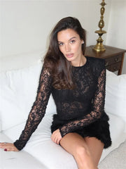 The lace mini dress emphasising the sheer sleeves, structured fit, and dimensional skirt for night-out styling.