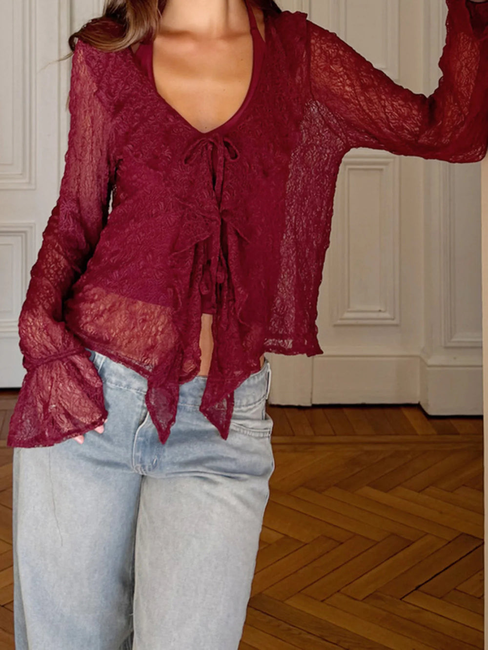 Close-up of the lace blouse neckline showing the tie-front detail and delicate texture.