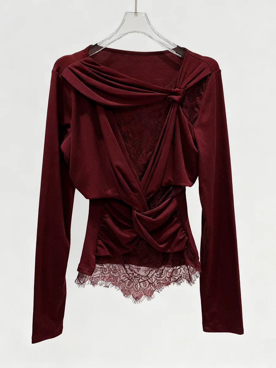Lace and fabric overlay draped long sleeve blouse on model