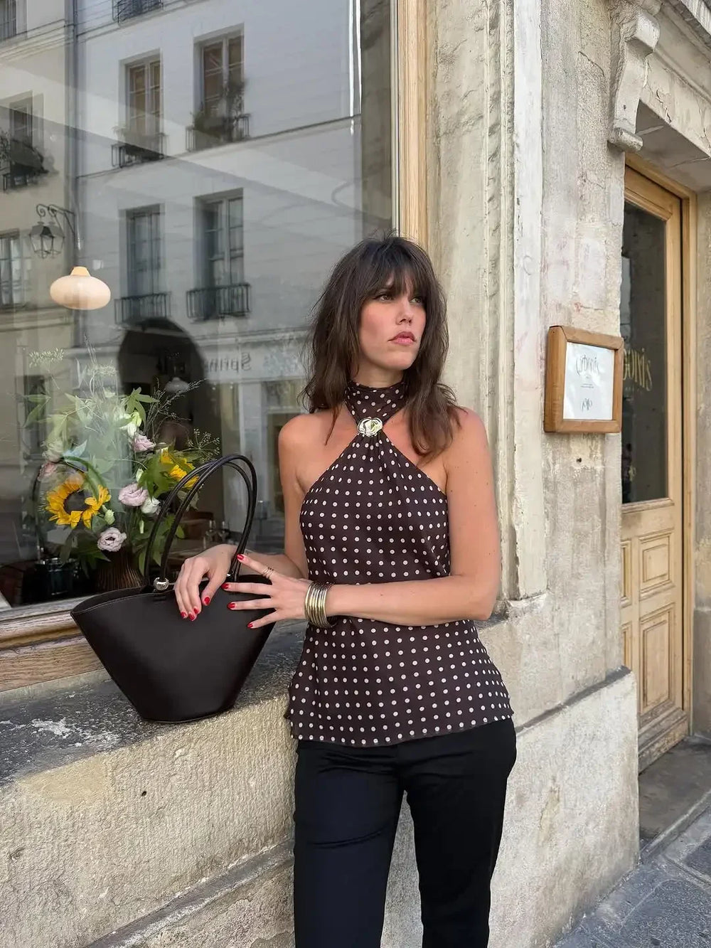 Lace-up back detail with a metal buckle accent on a halter top