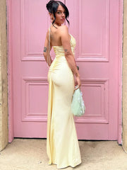 Backless yellow maxi dress styled for weddings and formal events