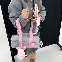 Vintage-inspired grey satchel with pink handles and zipper closure