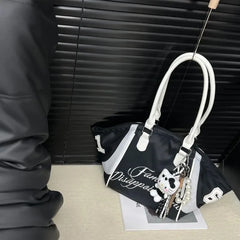 Sporty black nylon shoulder bag with white strap detailing