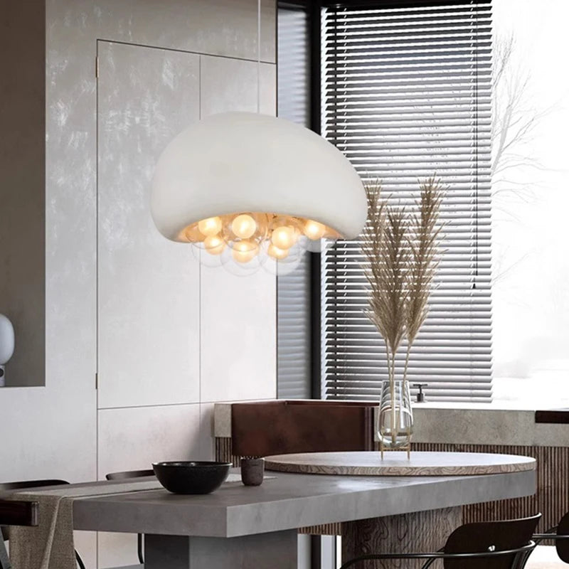 Large white dome pendant light over a dining table