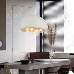 Large white dome pendant light over a dining table