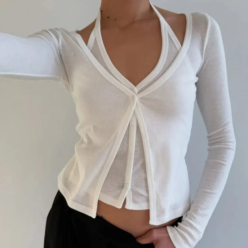 Model wearing a white layered halter knit top with long sleeves, photographed against a neutral background.