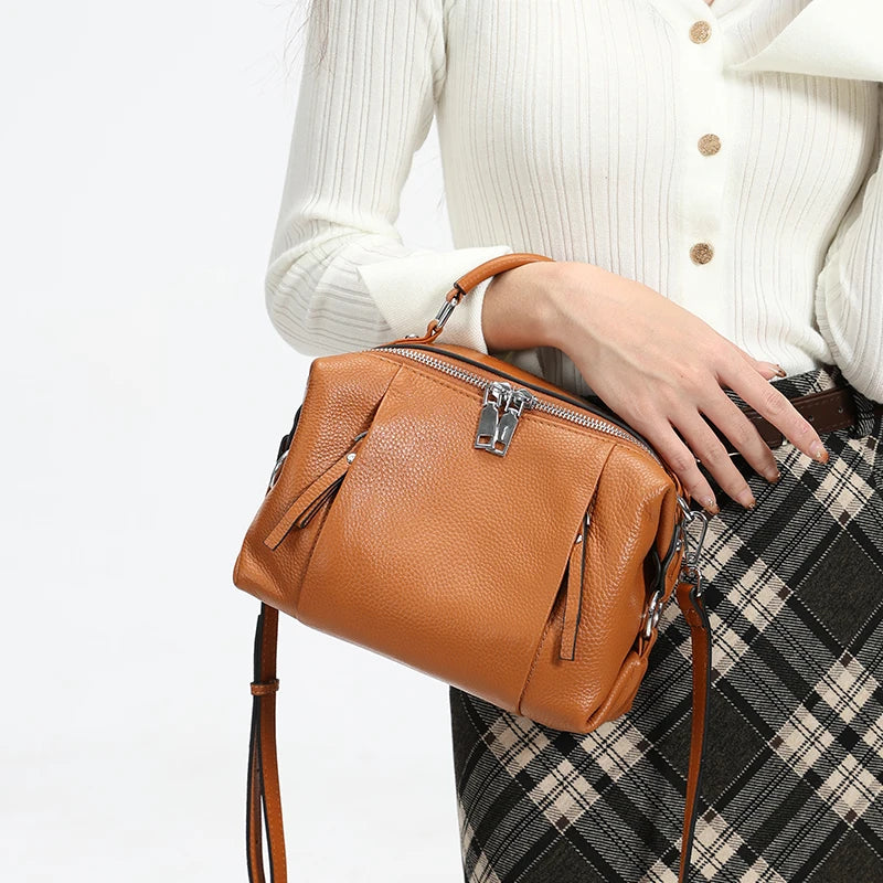 Women’s leather satchel featuring front zipper details and soft construction