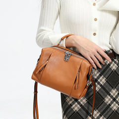 Women’s leather satchel featuring front zipper details and soft construction