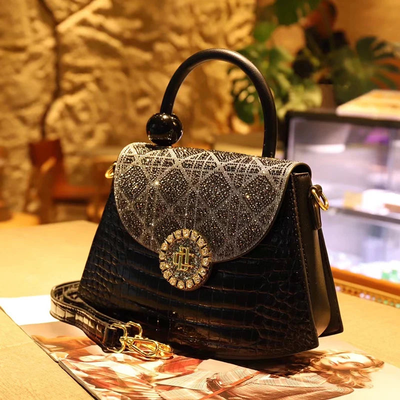 Leather saddle crossbody bag with diamond clasp
