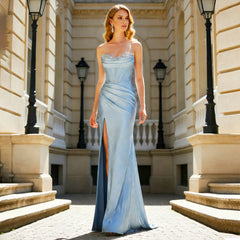 Model wearing a light blue beaded sweetheart satin mermaid gown with a side slit in a formal outdoor setting