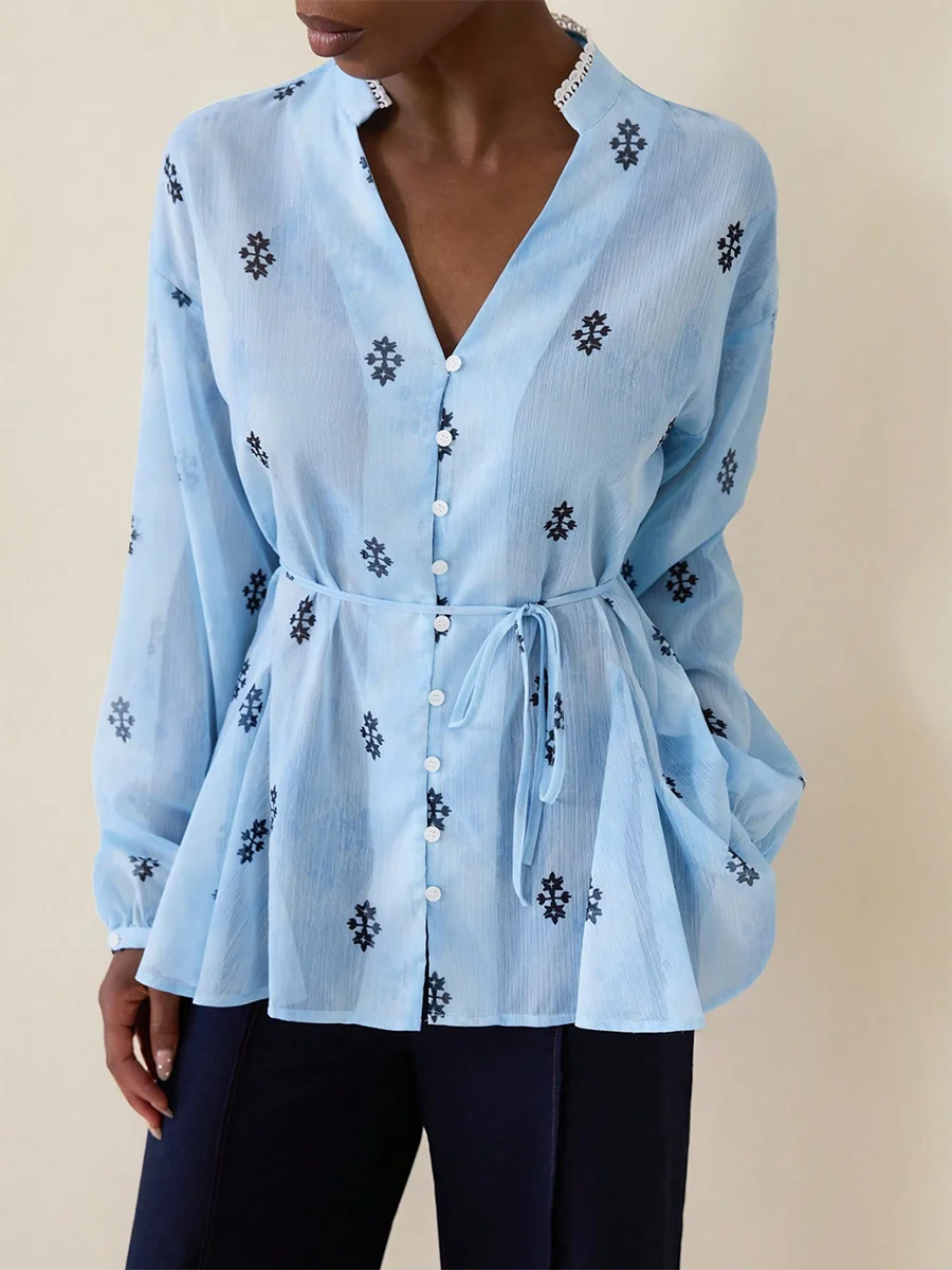 Light blue button-front blouse with black floral print and belt